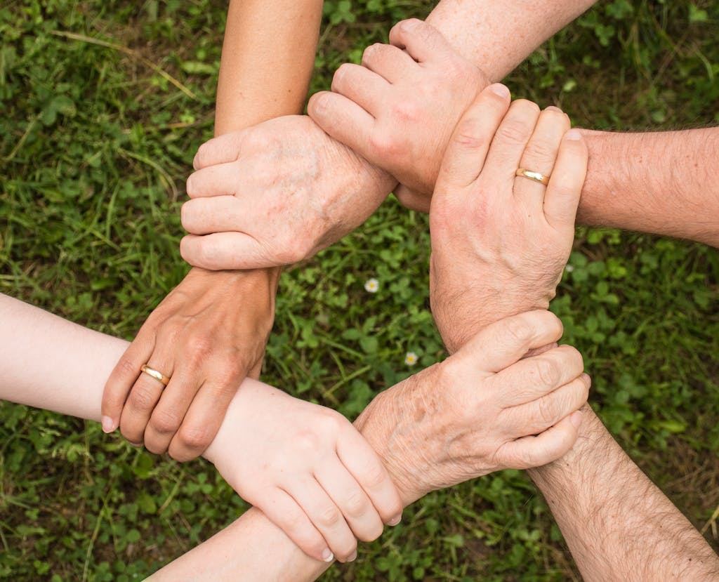 Close-up of diverse hands forming a connection, symbolizing teamwork and unity